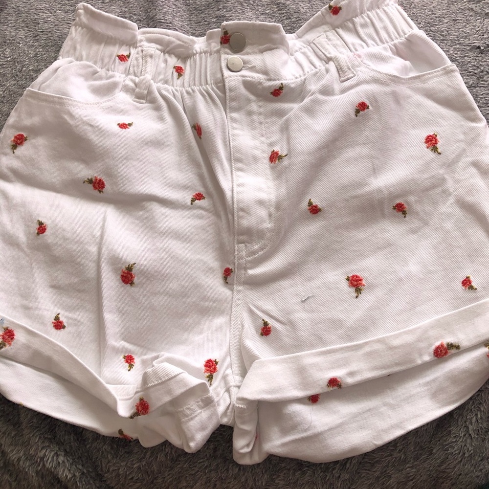 White shorts with detailed roses.